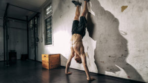 Man doing hand stand exercise