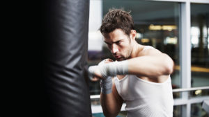 Man punching boxing bag