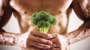 Healthy man holding broccoli