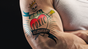 Toxic relationship tattoo on a man's bicep