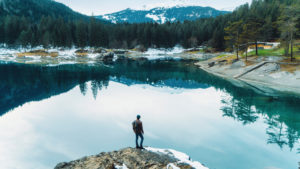 Silence - man looking at river and mountain